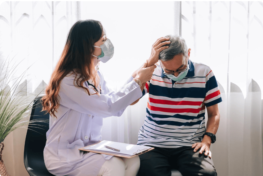 A man consulting a doctor for headache